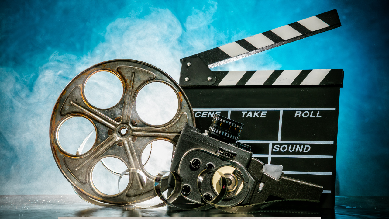 Vintage film reel, movie camera and clapperboard symbolising international cinema amid censorship debate at IFFK 2025